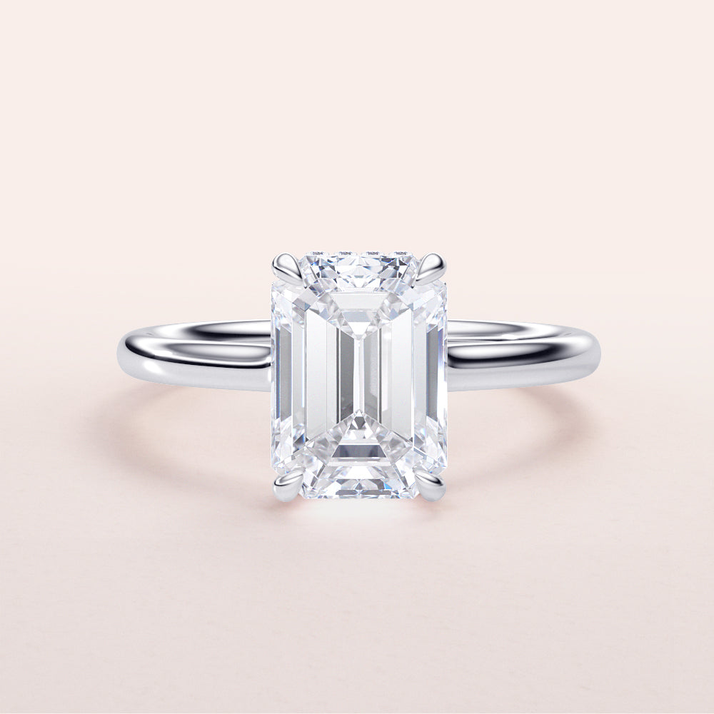 Elegant 14K/18K engagement ring featuring an emerald-cut diamond with an invisible gallery and hidden halo design.