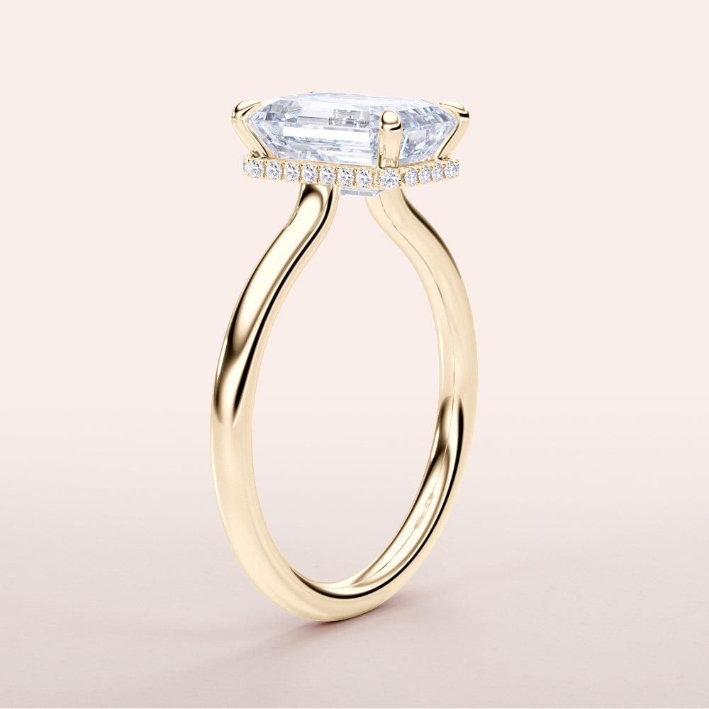 Elegant yellow gold engagement ring with emerald, featuring an invisible gallery and hidden halo. Available in 14K, 18K, or platinum.