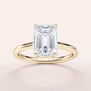 Elegant emerald-cut diamond solitaire engagement ring in yellow gold, available in 14K, 18K, or platinum, featuring a hidden halo.
#14KRecycledYellowGold
#18KRecycledYellowGold