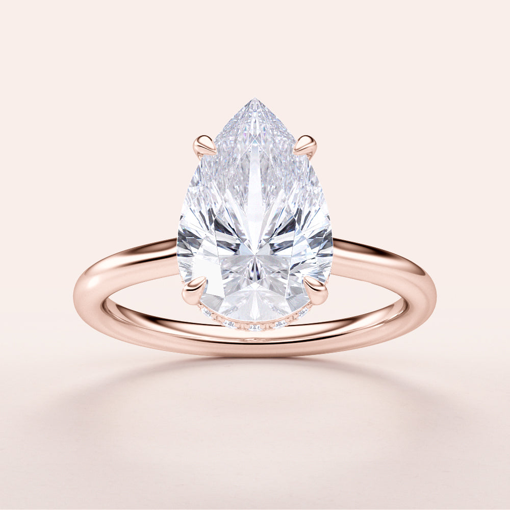 14K rose gold engagement ring featuring a pear-shaped diamond in solitaire setting. Elegant close-up of the hidden halo design.|







#14KRecycledRoseGold
#18KRecycledRoseGold



