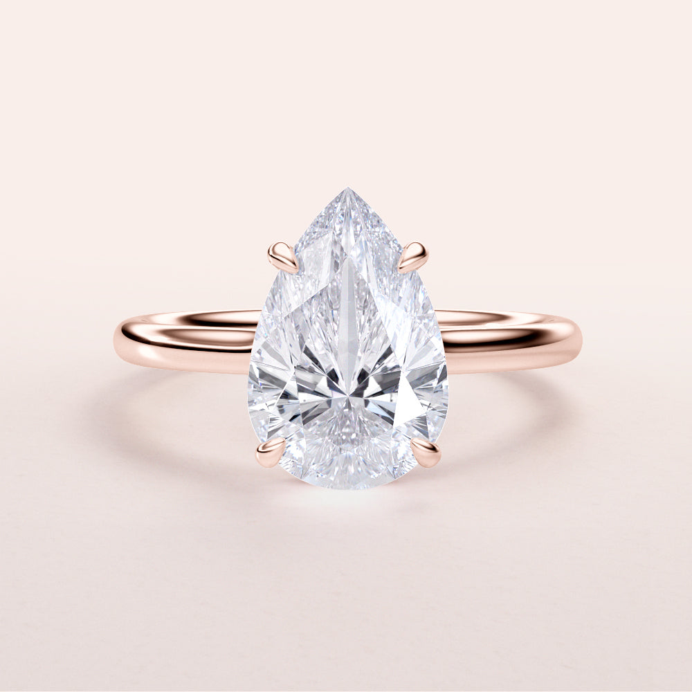 Exquisite pear-shaped diamond solitaire engagement ring in 14K or 18K rose gold, perfect for timeless elegance.|







#14KRecycledRoseGold
#18KRecycledRoseGold


