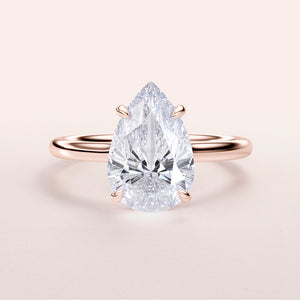 Exquisite pear-shaped diamond solitaire engagement ring in 14K or 18K rose gold, perfect for timeless elegance.