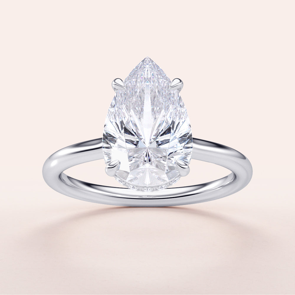 14K white gold solitaire engagement ring featuring a pear-shaped diamond with an invisible gallery and hidden halo.|

#14KRecycledWhiteGold
#18KRecycledWhiteGold








#Platinum