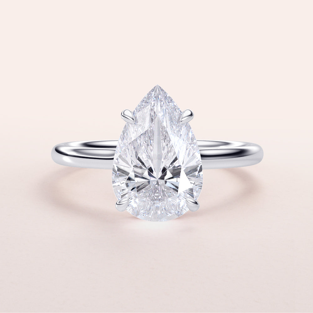 "Elegant pear-shaped diamond engagement ring in 14K or 18K gold and platinum, featuring a hidden halo and polished band."|

#14KRecycledWhiteGold
#18KRecycledWhiteGold








#Platinum