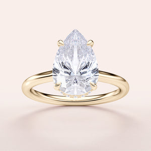 Pear-shaped diamond engagement ring in a sleek 14K gold band, featuring an elegant solitaire design.