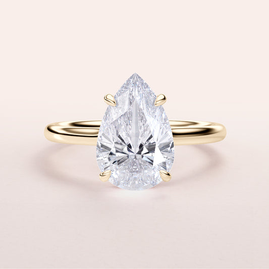 Pear-shaped diamond engagement ring with an invisible gallery and hidden halo in 14K/18K gold or platinum setting.