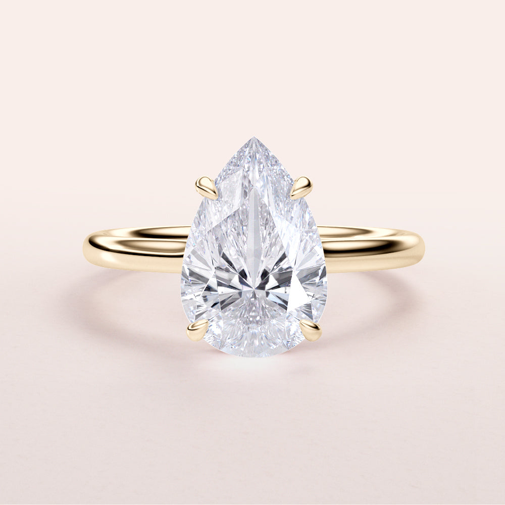 Pear-shaped diamond engagement ring with an invisible gallery and hidden halo in 14K/18K gold or platinum setting.