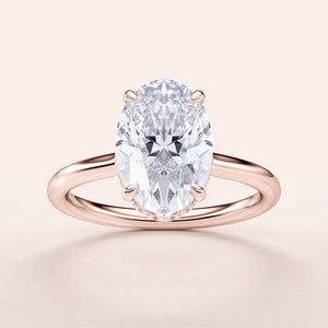 Elegant oval diamond engagement ring in rose gold, 14K and 18K options available, set in a polished band. Not worn on model.