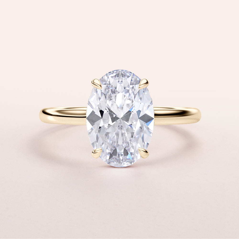 Elegant oval-shaped diamond engagement ring in 14K or 18K gold or platinum with hidden halo, perfect for proposals.
