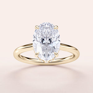 Elegant 14K yellow gold engagement ring with an oval diamond, showcasing timeless beauty in a hidden halo design.