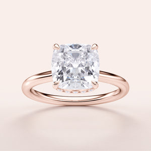 "Elegant 14K rose gold engagement ring featuring cushion-cut diamond with hidden halo. Jewelry piece not worn on model."