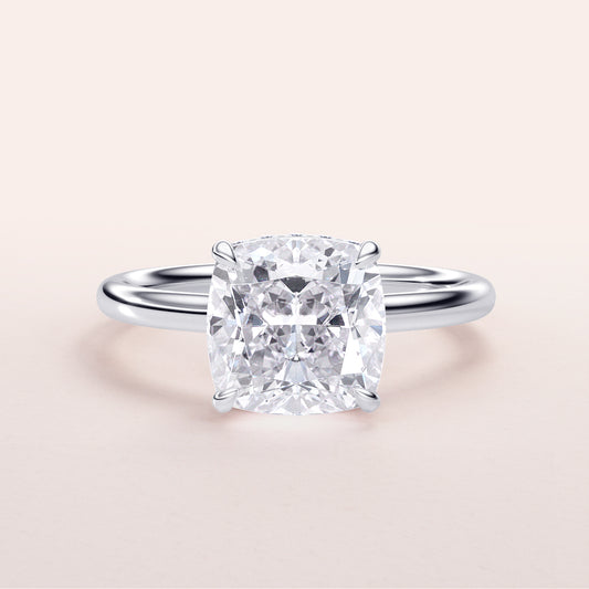 Elegant cushion-cut diamond engagement ring in 14K white gold, featuring a hidden halo and polished band, perfect for special occasions.