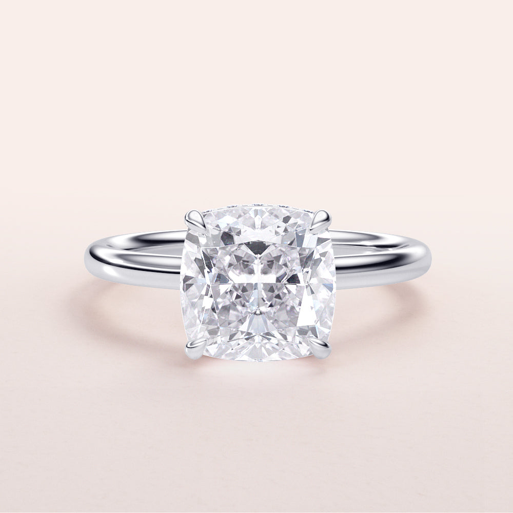 Elegant cushion-cut diamond engagement ring in 14K white gold, featuring a hidden halo and polished band, perfect for special occasions.