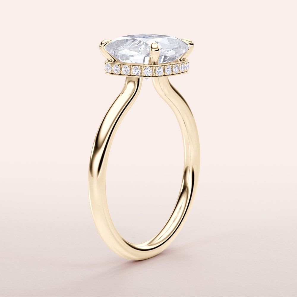 Elegant 14K or 18K yellow gold engagement ring featuring a cushion cut diamond with an invisible gallery and hidden halo.