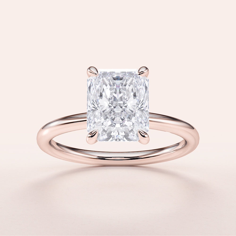 Radiant cut diamond solitaire engagement ring in 14K rose gold, perfect for timeless elegance and memorable moments.