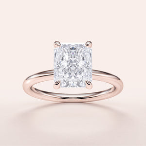 Radiant cut diamond solitaire engagement ring in 14K rose gold, perfect for timeless elegance and memorable moments.