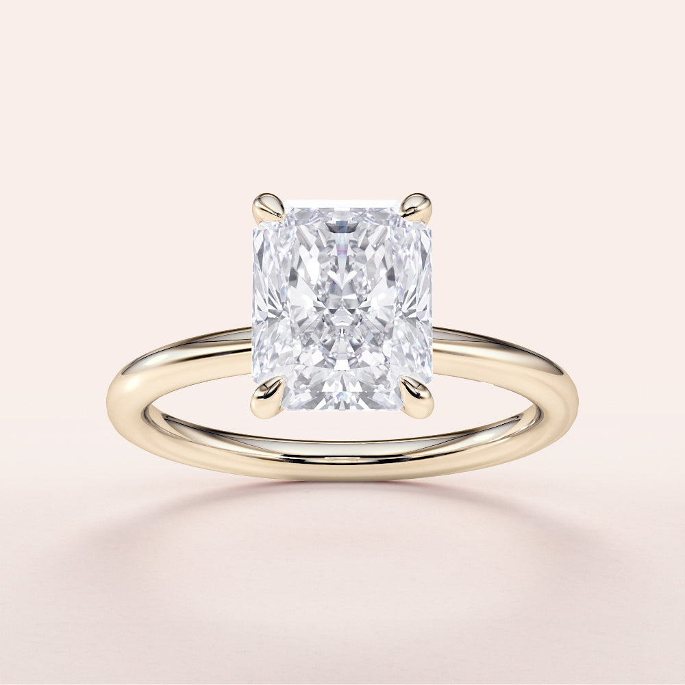 Radiant cut diamond engagement ring in 14K yellow gold setting, perfect for timeless elegance and modern romance.