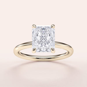 Radiant cut diamond engagement ring in 14K yellow gold setting, perfect for timeless elegance and modern romance.