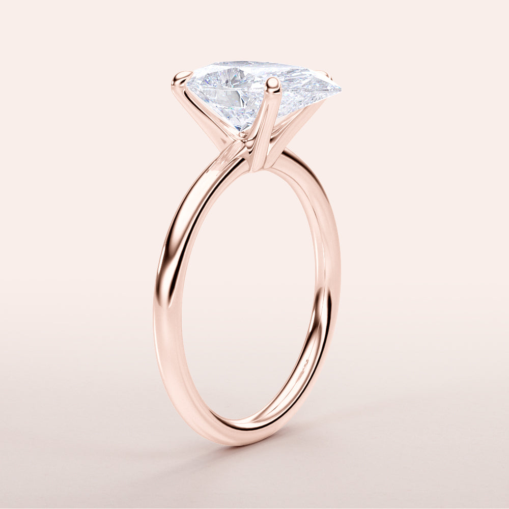 Elegant rose gold engagement ring featuring a stunning pear-shaped diamond, available in 14K, 18K, or platinum.|







#14KRecycledRoseGold
#18KRecycledRoseGold


