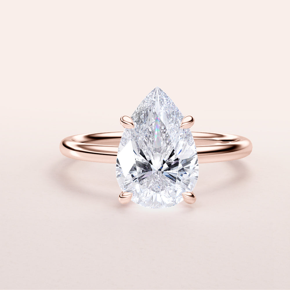 Elegant pear-shaped diamond solitaire engagement ring in 14K/18K rose gold, featuring a dazzling center stone.|







#14KRecycledRoseGold
#18KRecycledRoseGold


