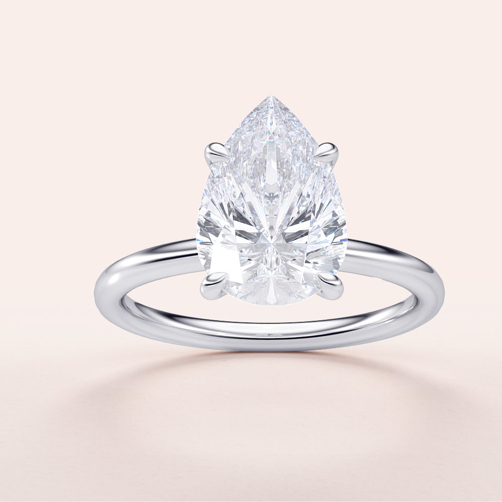 Stunning pear-shaped diamond solitaire engagement ring in 14K or 18K gold, expertly cut for maximum sparkle.|

#14KRecycledWhiteGold
#18KRecycledWhiteGold








#Platinum