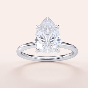 Stunning pear-shaped diamond solitaire engagement ring in 14K or 18K gold, expertly cut for maximum sparkle.