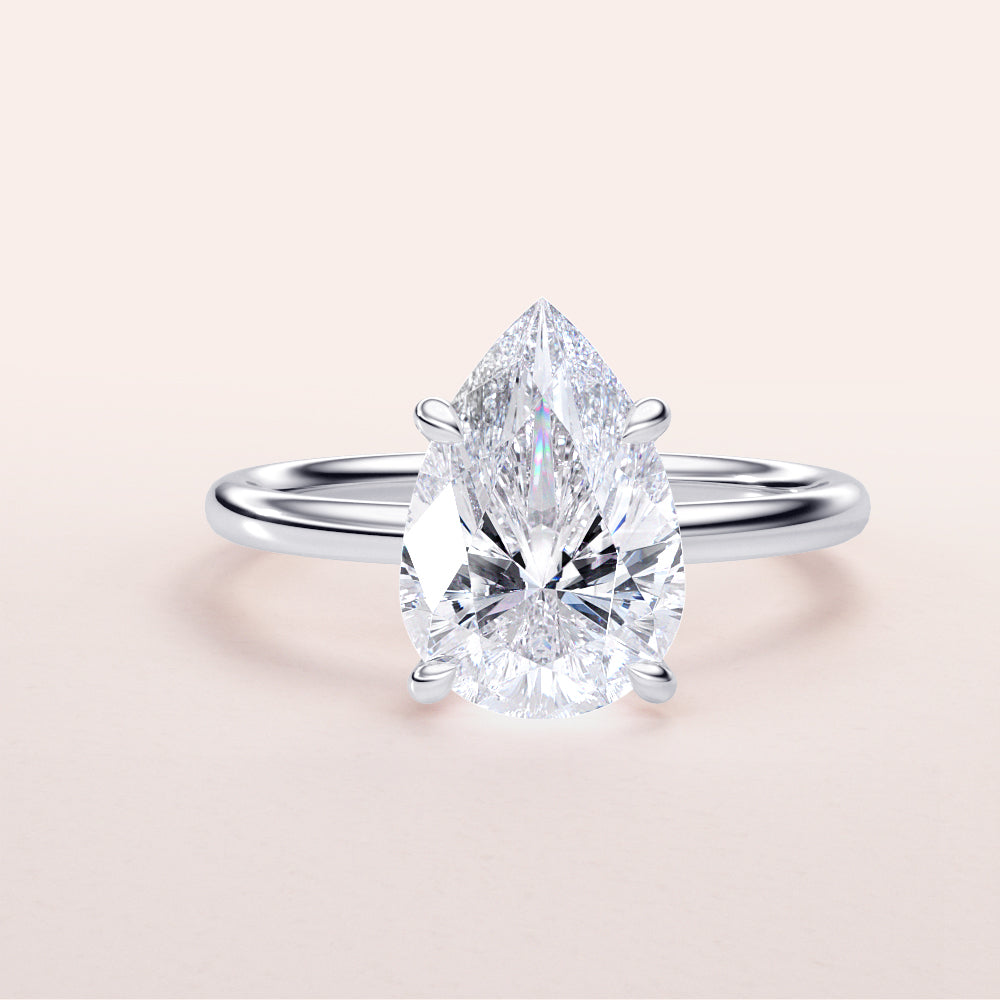 Elegant pear-shaped diamond engagement ring in 14K or 18K white gold or platinum setting, showcasing timeless beauty and sophistication.|

#14KRecycledWhiteGold
#18KRecycledWhiteGold








#Platinum