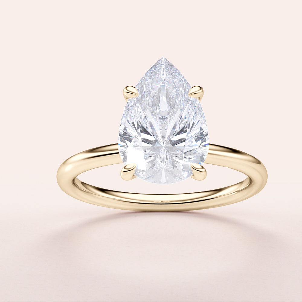 Pear-shaped diamond engagement ring on a sleek 14K yellow gold band, featuring an elegant design with a brilliant teardrop diamond.|




#14KRecycledYellowGold
#18KRecycledYellowGold





