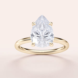 Pear-shaped diamond engagement ring on a sleek 14K yellow gold band, featuring an elegant design with a brilliant teardrop diamond.
