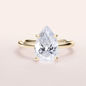 14K gold pear-shaped diamond solitaire engagement ring, elegantly designed to enhance the diamond's brilliance and beauty.