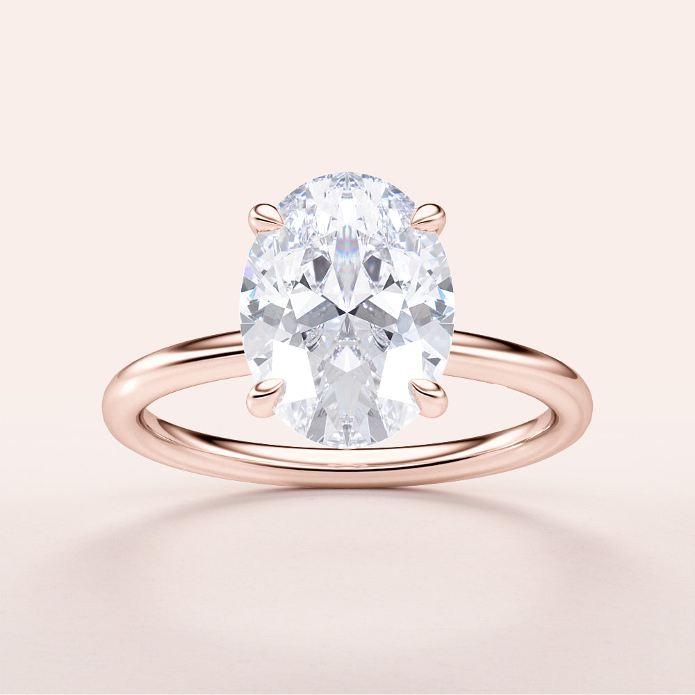 "Elegant oval classic solitaire engagement ring in rose gold, available in 14K or 18K gold or platinum for timeless beauty."