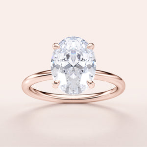"Elegant oval classic solitaire engagement ring in rose gold, available in 14K or 18K gold or platinum for timeless beauty."