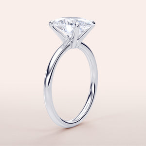 Elegant 14K white gold oval classic solitaire engagement ring featuring a round-cut diamond in a timeless prong setting.