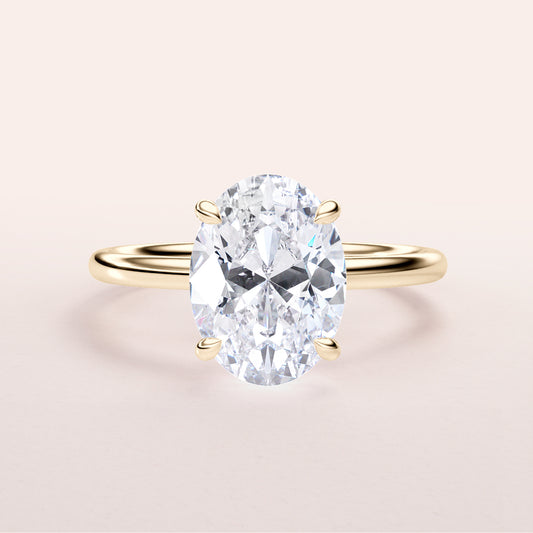 14K yellow gold engagement ring featuring a stunning oval-cut diamond center stone. Elegant and timeless design for proposals.