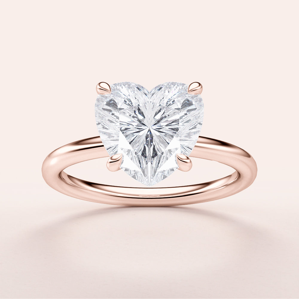 Elegant heart-shaped diamond engagement ring in 14K or 18K rose gold, showcasing a sparkling solitaire heart-cut diamond.|







#14KRecycledRoseGold
#18KRecycledRoseGold


