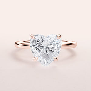 Heart-shaped diamond engagement ring in 14K or 18K rose gold, showcasing classic solitaire design. Shown unmodeled.