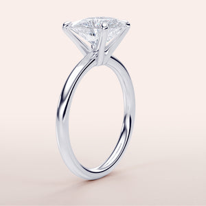 Elegant 14K white gold solitaire engagement ring featuring a pear-shaped diamond, perfect for timeless love and special occasions.