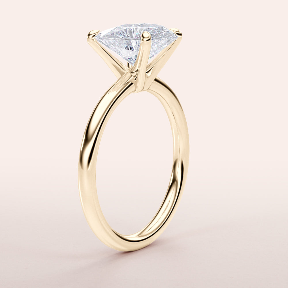 Elegant 14K yellow gold engagement ring featuring the Halley heart classic solitaire design with a stunning trillion-cut diamond.|




#14KRecycledYellowGold
#18KRecycledYellowGold





