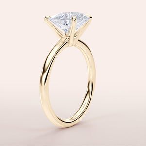 Elegant 14K yellow gold engagement ring featuring the Halley heart classic solitaire design with a stunning trillion-cut diamond.