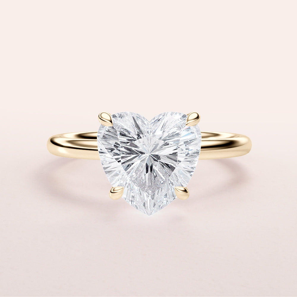 Elegant heart-shaped diamond ring in 14K or 18K yellow gold or platinum, featuring a brilliant cut diamond centerpiece.|




#14KRecycledYellowGold
#18KRecycledYellowGold





