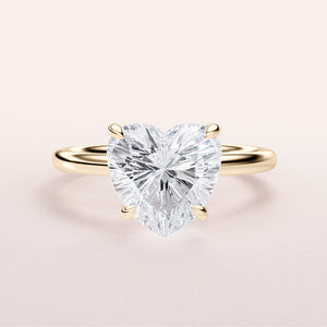 Elegant heart-shaped diamond ring in 14K or 18K yellow gold or platinum, featuring a brilliant cut diamond centerpiece.