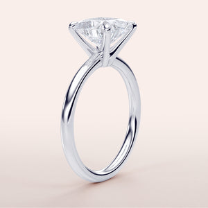 Elegant white gold solitaire engagement ring featuring a marquise-cut diamond, available in 14K, 18K, or platinum.