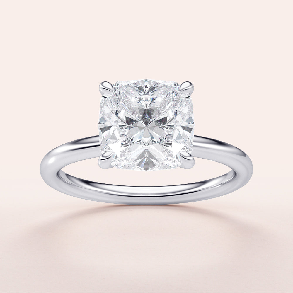 Elegant 14K or 18K white gold or platinum cushion-cut diamond solitaire engagement ring, featuring timeless design.|

#14KRecycledWhiteGold
#18KRecycledWhiteGold








#Platinum