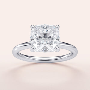Elegant 14K or 18K white gold or platinum cushion-cut diamond solitaire engagement ring, featuring timeless design.