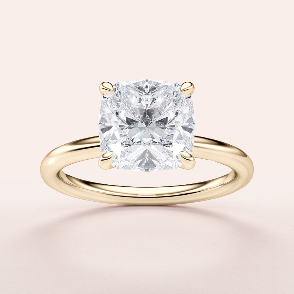 Elegant 14K yellow gold cushion cut diamond solitaire engagement ring showcasing a brilliant cushion-shaped diamond.|




#14KRecycledYellowGold
#18KRecycledYellowGold





