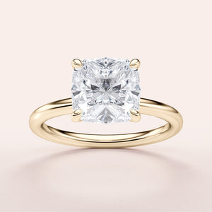 Elegant 14K yellow gold cushion cut diamond solitaire engagement ring showcasing a brilliant cushion-shaped diamond.