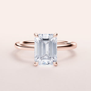Close-up view of EMERALD-cut diamond engagement ring in rose gold, available in 14K, 18K, or platinum. Exquisite craftsmanship!