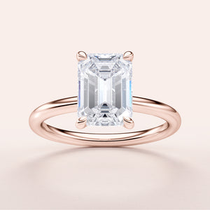Emerald-cut diamond engagement ring in 14K rose gold, featuring a polished band for a timeless, elegant design.