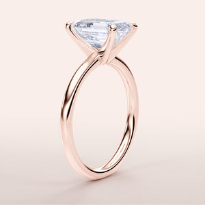Elegant 14K rose gold engagement ring featuring a stunning elongated trapezoid-shaped diamond, exuding timeless luxury.