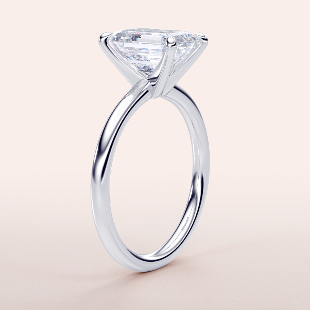 Platinum or 14K/18K white gold engagement ring with a stunning emerald, set in a minimalist band design, classic elegance.|

#14KRecycledWhiteGold
#18KRecycledWhiteGold








#Platinum